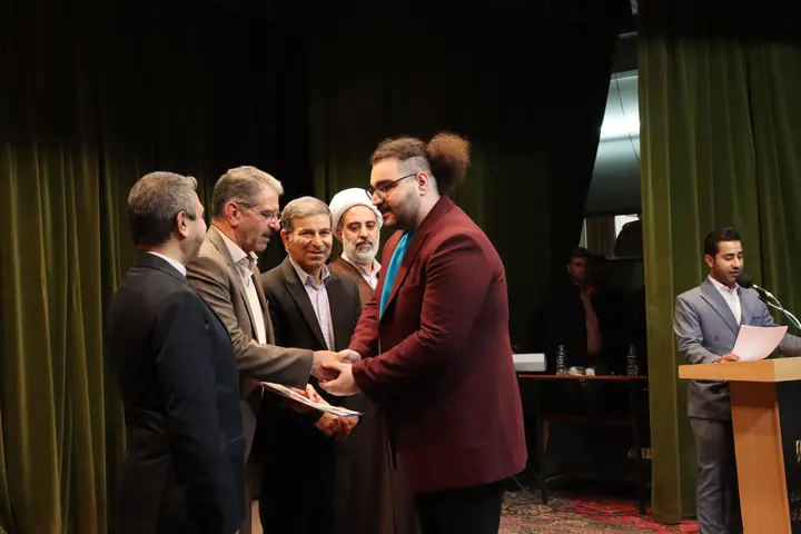 AmirHossein Abdollahi receiving the Hi-Tech 2025 honorary diploma on stage