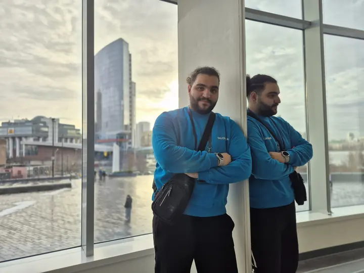 AmirHossein Abdollahi behind a window overlooking the city of Yekaterinburg — BRICS Hi-Tech 2025 trip